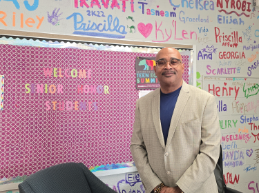 man standing in front of pink wall